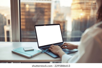 Business woman using laptop in office sitting at desk. Female hands typing on computer white blank mock up empty screen display for business websites or services ads. Over shoulder view. Close up - Shutterstock ID 2295886613