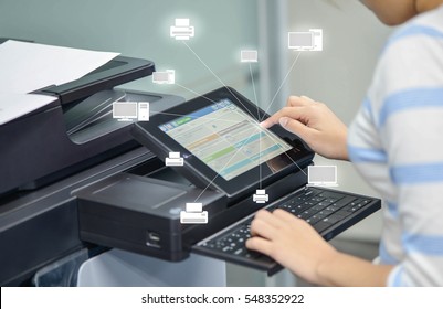 Business woman is using the printer to scanning document to network folder with icon of printer and computer