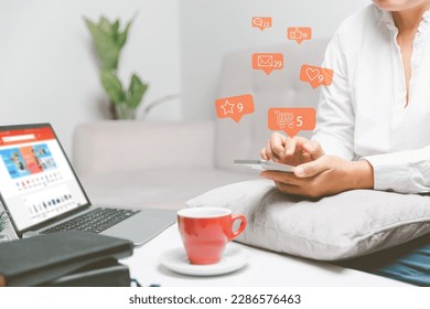 Business woman using smart phone with social network service or SNS, Social media concept. Woman using laptop computer and staying at home for online marketing business. social media business. - Powered by Shutterstock