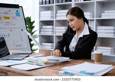 Business woman using smartphone for contract customer on wooden desk in office, tax, accounting, statistics and analytic research concept - Shutterstock ID 2310775903