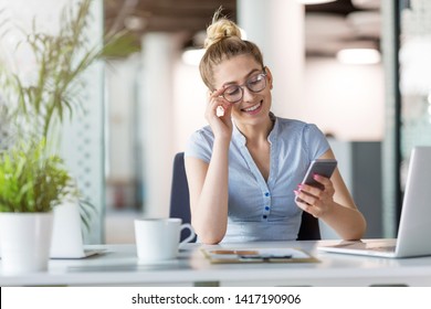 Business woman using smartphone in office - Shutterstock ID 1417190906