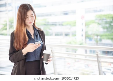 Business Woman Using Smartphone Shopping Online, Call, Texting Message Internet Technology Lifestyle. Asian Woman Using Cellphone Walking On City Street. Smart Phone Smart Confident Woman Modern City