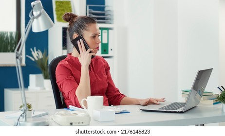 Business Woman Using Smartphone To Talk To Project Manager, Working On Charts Statistics. Company Employee Having Phone Call Conversation In Startup Office To Do Financial Research.