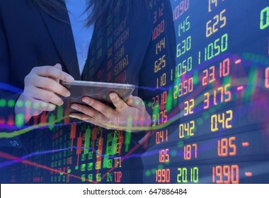 Business woman Using Tablet and DOUBLE Exposure Statistic Index Graph STOCK MARKET Financial Indicator Data and BUSINESS Woman Analysis Graph Background. Fintech Financial Internet Technology Trading 
