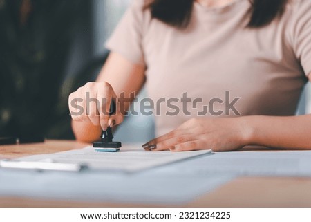 business woman validates and manages business documents and agreements ,approval stamp ,signing a business contract approval ,contract documents confirmation or warranty certificate ,Signing a form 