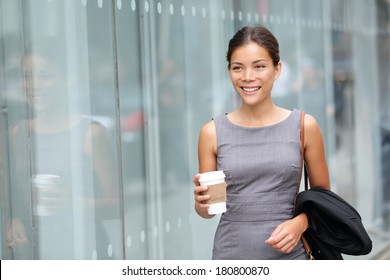 Business Woman Walking Drinking Coffee. Lawyer Professional Or Similar Walking Outdoors Happy Holding Disposable Paper Cup. Multiracial Asian / Caucasian Businesswoman Smiling Happy Outside.