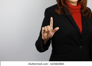 Business Woman Wearing Black And Red Business Suit Uniform With Confident While Pointing Something On White Background Studio (advertisement Concept)