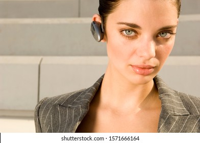 A Business Woman Wearing A Bluetooth Earpiece