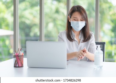 Business woman wearing mask and using personal sanitizer to cleaning her hand in office to keep hygiene.Preventive during the period of epidemic from coronavirus or covid19. - Powered by Shutterstock