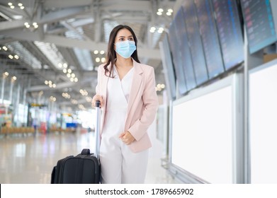 A Business Woman Is Wearing Protective Mask In International Airport, Travel Under Covid-19 Pandemic, Safety Travels, Social Distancing Protocol, New Normal Travel Concept.