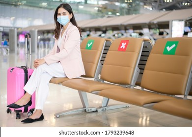 A Business Woman Is Wearing Protective Mask In International Airport, Travel Under Covid-19 Pandemic, Safety Travels, Social Distancing Protocol, New Normal Travel Concept.