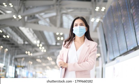 A Business Woman Is Wearing Protective Mask In International Airport, Travel Under Covid-19 Pandemic, Safety Travels, Social Distancing Protocol, New Normal Travel Concept.