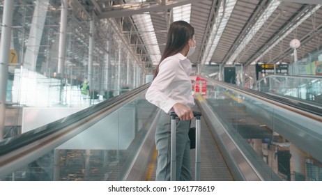 A Business Woman Is Wearing Protective Mask In International Airport, Travel Under Covid-19 Pandemic, Safety Travels, Social Distancing Protocol, New Normal Travel Concept