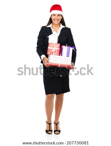 Business woman wearing a santa claus hat holding parcels in her hands and is smiling.   Isolated on a white background. 