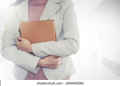 Business woman wearing a white suit, holding a document for starting a business office, interview the pride of a business.
 - Shutterstock ID 1404490385