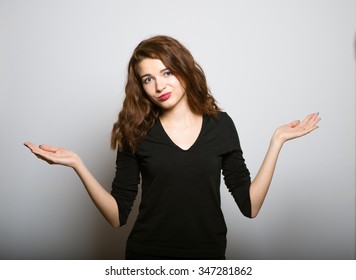 Business Woman Weighing The Pros And Cons, Studio Shot Isolated On The Gray Background