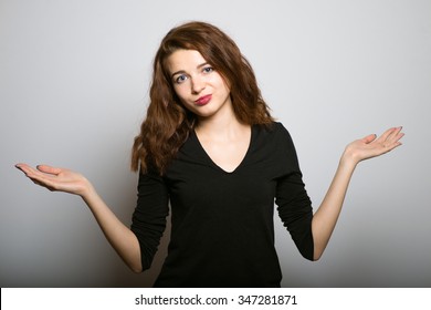 Business Woman Weighing The Pros And Cons, Studio Shot Isolated On The Gray Background