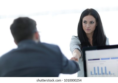 business woman welcomes colleague with handshake