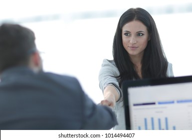 business woman welcomes colleague with handshake