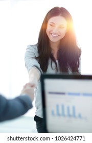 business woman welcomes colleague with handshake