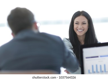 business woman welcomes colleague with handshake
