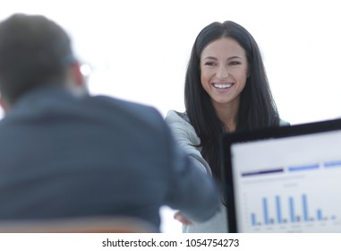 business woman welcomes colleague with handshake