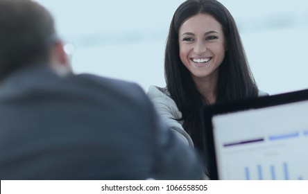 business woman welcomes colleague with handshake