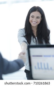business woman welcomes colleague with handshake