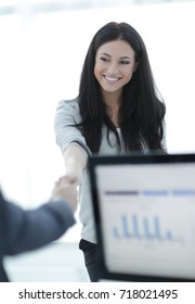 business woman welcomes colleague with handshake
