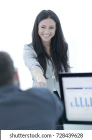 business woman welcomes colleague with handshake