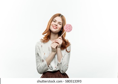 business woman in a white shirt on a light background with pain smiles