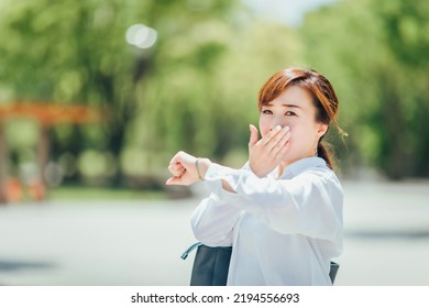 A Business Woman Who Is Impatient To See Her Wristwatch (late, Busy)