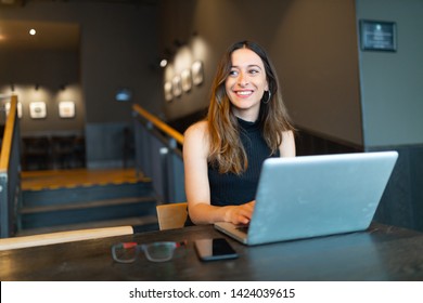 Business woman work process concept. Young woman working university project with generic design laptop. Blurred background, film effect.