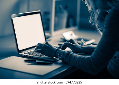 Business Woman At Work. Woman Working At Night In Front Of Her Laptop Computer. Night Shift. Bluish Color Grading.