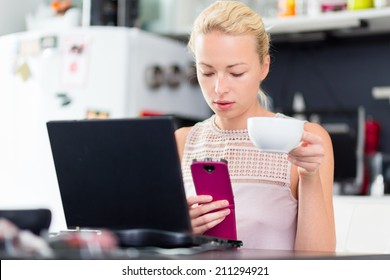 Business Woman Working From Her Home. Multitasking. Having Morning Coffee While Texting On The Smarth Phone And Working On Leptop Computer.