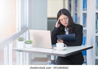 Business woman working with laptop in workstation.