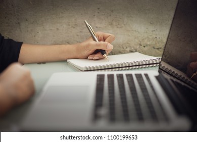 Business woman working at office with laptop and documents on his desk, Business woman holding pens and papers making notes in documents on the table, Hands of financial manager taking notes - Shutterstock ID 1100199653