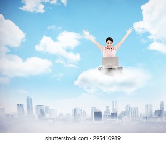 Business woman working on the cloud above the city. Cloud computing concept