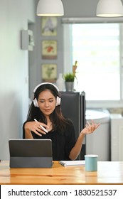 Business Woman Working On Digital Tablet At Home While Video Call Conference Call With Business Partner Group.