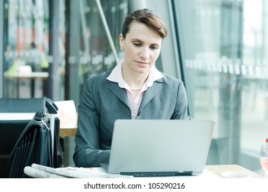 Business woman working on notebook at the airport lounge - Shutterstock ID 105290216