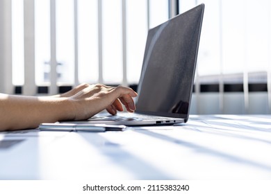 A business woman working in a private room, She is typing on a laptop keyboard, She uses a messenger to chat with a partner. Concept of using technology in communication. - Shutterstock ID 2115383240