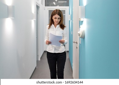 Business Woman Working At The Reception In The Hospital, Girl With Documents At The Reception In The Office, Administration