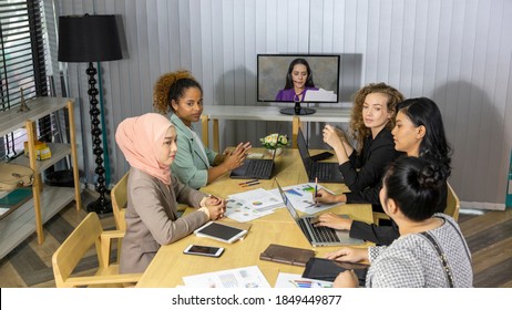 Business Women From Different Ethnic Races And Cultures Having A Tele Conference With Colleague In An Office For Business Development Or Plan