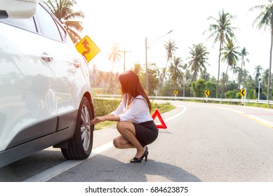 Business Women Driver Changing Tyre On Her Broken Car.