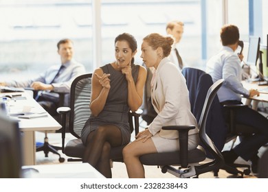 Business women gossiping in office - Powered by Shutterstock