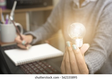 Business Women Hand Holding Light Bulb, Concept Of New Ideas With Innovation And Creativity.