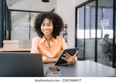 Business women hand working with tablet and laptop computer with documents on office desk in modern office. - Shutterstock ID 2261968457