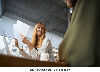 Business women leading meeting focused on clothing design - Powered by Shutterstock