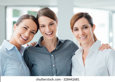 Business Women Posing Together In The Office And Smiling At Camera, Teamwork And Women Empowerment Concept