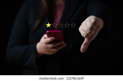 Business women select bad face emoticon on virtual touch screen at smartphone. Bad review, bad service dislike bad quality, low rating, social media not good - Shutterstock ID 2157811659